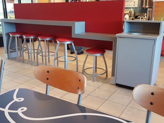 Love rmthe red bar stools and bar seating area