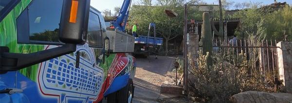 Goodman's work truck lowering a boulder