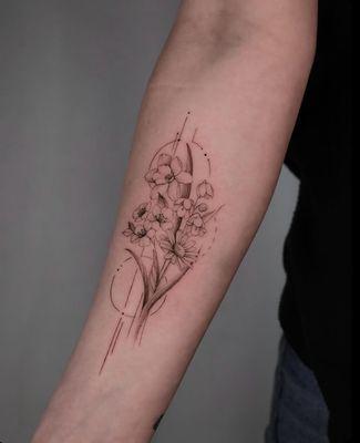 Fine line birth month flower tattoo by Szilvia