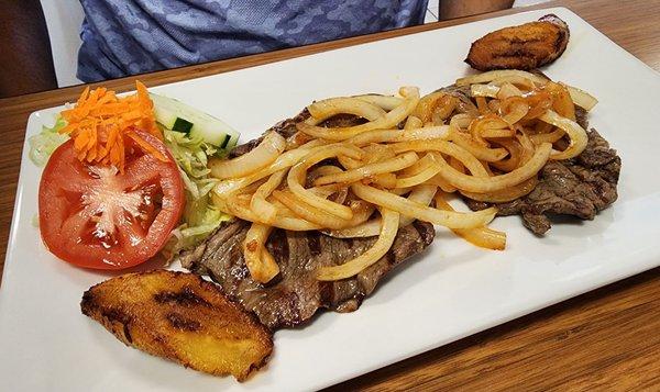 Bistec Encebollado: Top round steak with juicy grilled onions