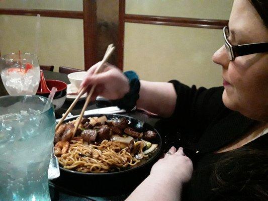 My wife eating hibachi steak with fried rice, noodles and mixed vegetables