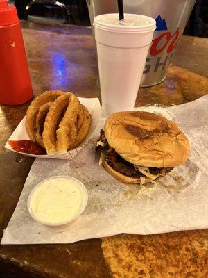 Swiss mushroom burger with bacon and grilled onions and a side of onion rings with ranch.