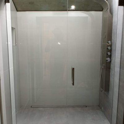 Frameless hinged shower door