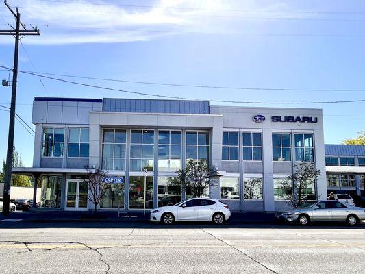 Outside the dealership with available street parking