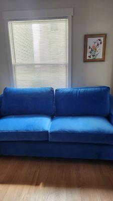 Electric blue sofa about 82" wide.