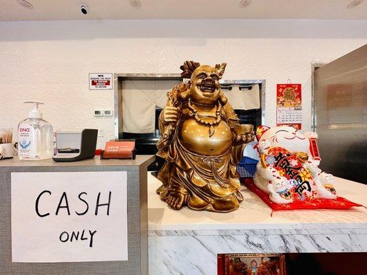 Cash only sign and lucky Buddha