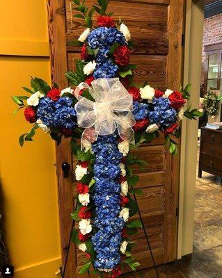 Patriotic floral cross spray for a US Veteran