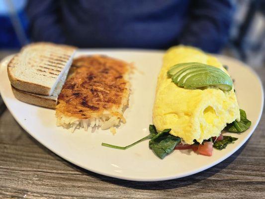 Greek Omelet with side of hashbrowns and toast.