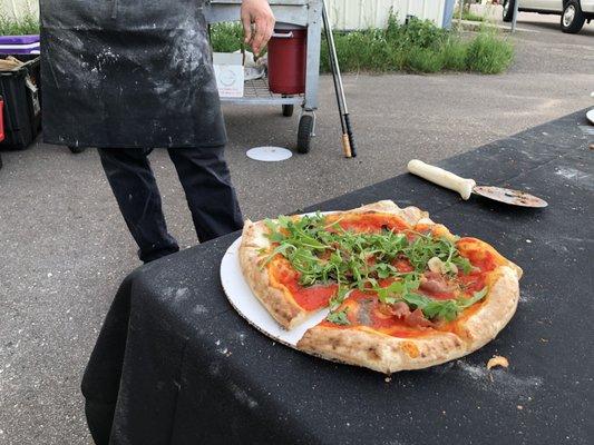 Finished pizza, prosciutto, anchovy, tomato sauce, garlic, olive oil and arugula. Tastes even better then it looks!