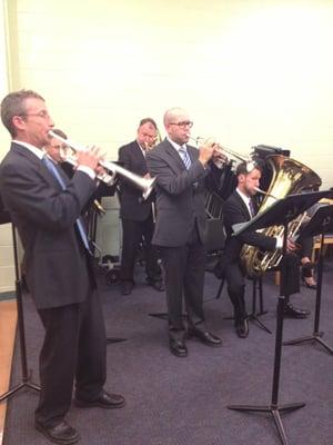 Brass section performing a special piece for our VIP Club families backstage