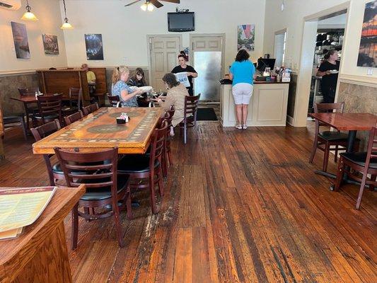 Look at those beautiful wooden floors! There's a nice distance between tables in this room.