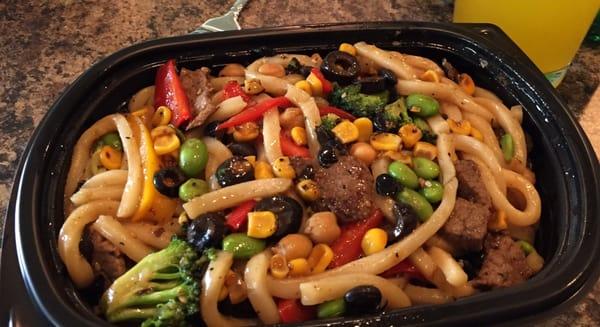 The wok bowl with udon noodles, beef, & other goods from the salad bar + teriyaki sauce