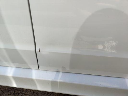 Dent in the passenger door.