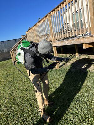 Our Pest Control Technician Edward,  Spraying Treatment on the Outside Perimeter of Property.