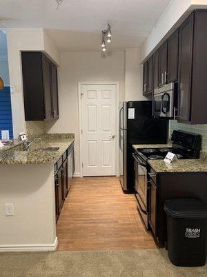 Updated kitchen w marble countertop & black stainless steel appliances