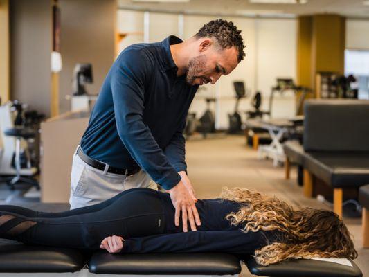 Therapist examining patient's lower back