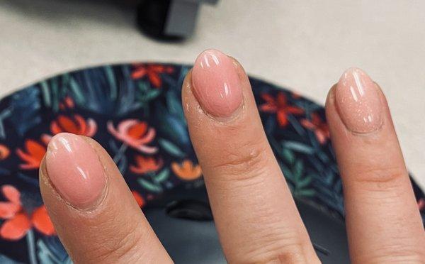 Glam nail dip mani. Huge crack and chip on the one on the left.  Cuticles in bad shape because they paid no attention to them.