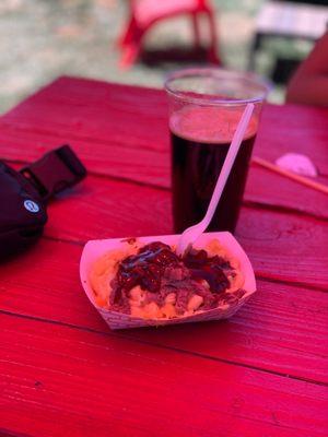 Mac n cheese with tritip and a black lager