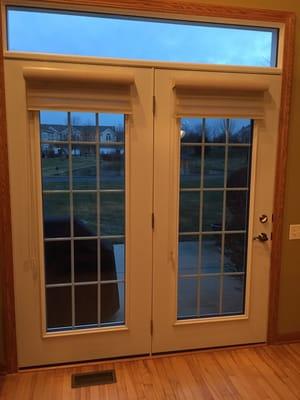 New custom-built patio door with window shade (not included). The color is white.