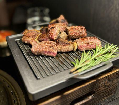 45 Day Camembert Cheese Aged Ribeye - grilled, cut, and placed on a warmer by our server