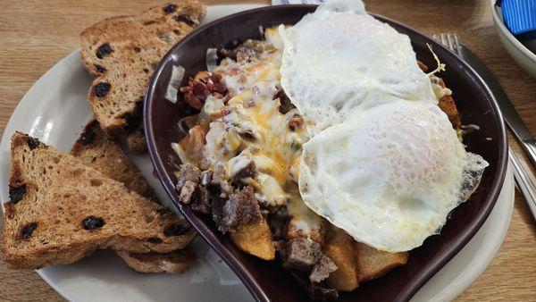 TPI Skillet. American Fries. Hash browns would be better. Bacon and a nice diced sausage. Eggs over easy. Raisin Toast.