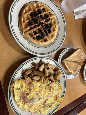 Bberry belgian waffle. Thought it came with whipped cream, nope. Atown omelet, 4 eggs, bacon, ham, sausage, onion, pepper, tomato, shrooms.