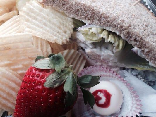 Chicken salad club sandwich on wheat with chips, fruit and treat