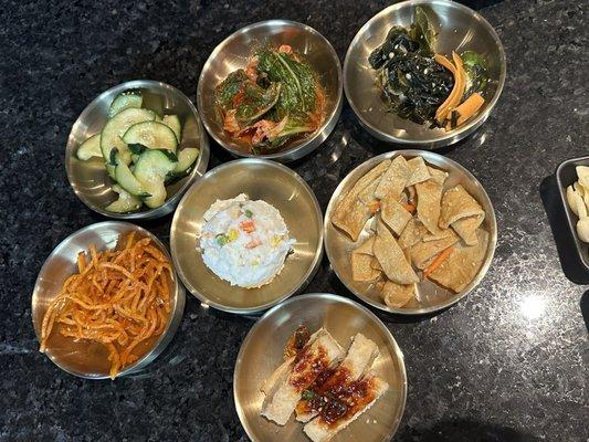 Banchan: squid, mashed potatoes, cucumber, kimchi, seaweed, fish cake, and fried tofu