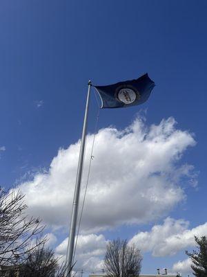 The Kentucky state flag blowing in the breeze at the library.