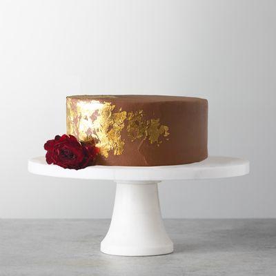 7" Chocolate Foiled cake in dark chocolate cake layers with dulce de leche filling and edible gold leaf details.