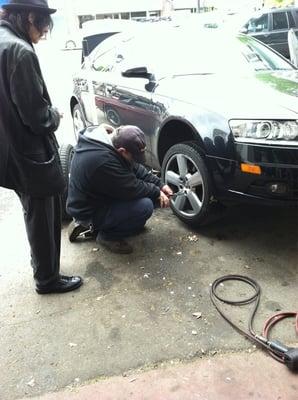 Joe helping Peter Wolf change a tire