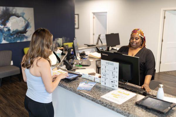 chiropractic patient checking in at front desk