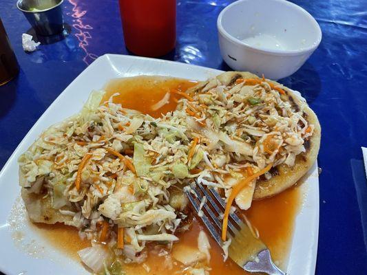 Lorocco and Calabaza pupusas with cabbage and sauce.