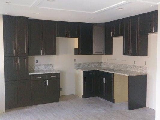 Espresso Cabinets and Tiger skin white granite.