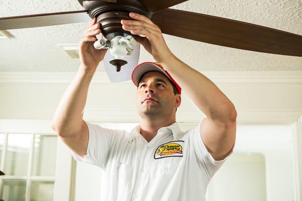 Mister Sparky installing a fan.