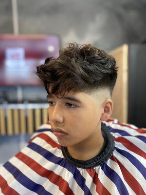 Texturized crop top hair haircut with a drop fade, and an edge up to complete the style.