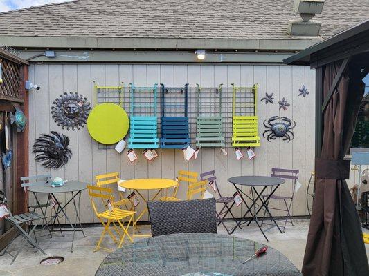 A wall of colorful outdoor furniture