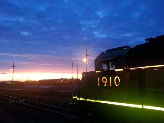 Sunset going down over the Union Pacific Railroad behind engine 1910.