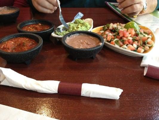 Chips, salsa, beans, guacamole, and pico de gallo.