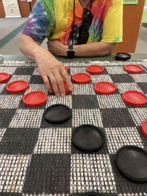 Playing community checkers