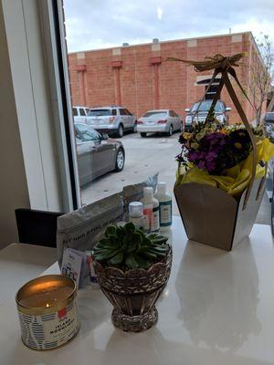 Candle, plants, and hair products at the front counter