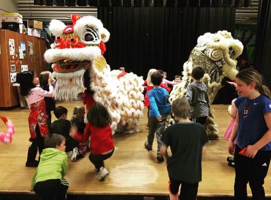 White Lotus Dragon & Lion Dance Organization performing for a young crowd at Atkinson Elementary School Lunar New Year event. Portland, OR