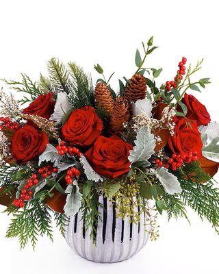 Long Beach Winter-Bright red roses and seasonal greens and textures are presented in a designer white and gold ceramic vase.