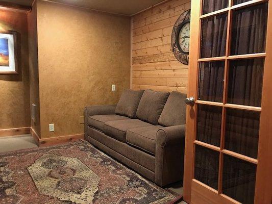 The Library Room of the Lodge. A queen sofa sleeper with luscious bedding.