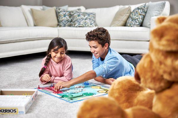 Boy and girl playing on clean carpet