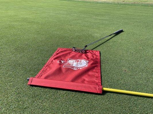 Scotty Cameron Terryllium T22 nestled for a model shoot on the flag