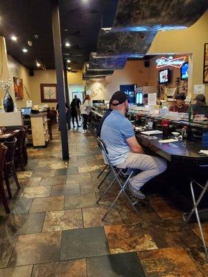 Picture of the restaurant and the sushi bar area they also have tables