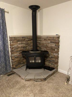 Stove install with hearth pad and stone wall install