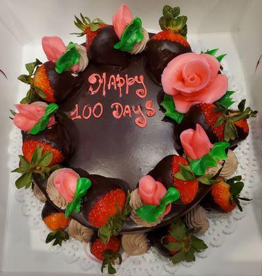 Chocolate cake with chocolate mousse including chocolate covered strawberries on top any bottom