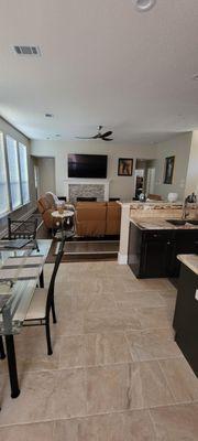 Full kitchen and family room remodel with quartzite countertops, hardwood flooring, stained cabinets, and stacked stone fireplace